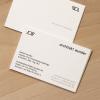 Architekt wunder business card shown on both sides in studio lighting on a wooden desk