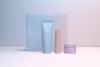 Four Covey Skincare packaging design products facing forward in studio lighting against a gradient fading from soft blue to light pink
