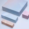 Covey Skincare packaging designs laid flat in studio lighting on a blue background