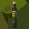 Mia Via Olive Oil Limited Edition packaging design featuring a single bottle of olive oil centered on a full-bleed background of abstract geometric shapes in various shades of green
