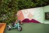 Colorful mural of a mushroom character with a pinecone character on its head in the garden of Pinecone Childcare in Portland, Oregon.