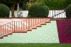 View of a set of stairs with a colorful mural painted on its walls in the garden at Pinecone Childcare in Portland, Oregon.