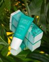 tube and box packaging design for selfless by hyram repair serum, photographer against a leafy jungle-like background