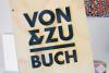 Von and Zu Buch Book Store logo , burnt onto a wooden sign in a retail space